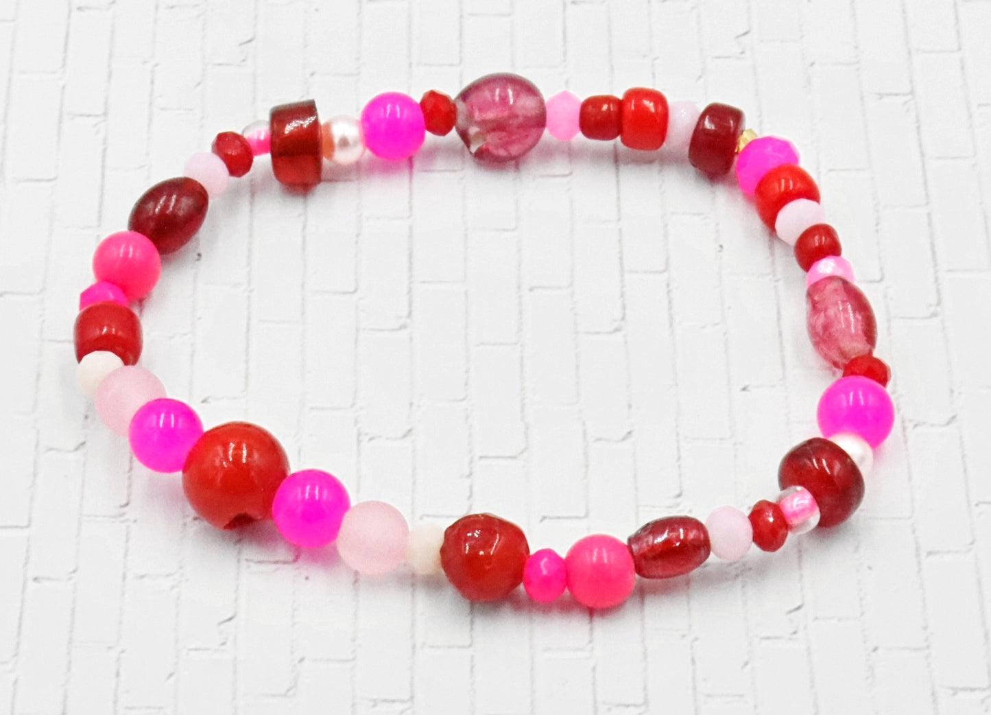 A Bite Out of Our Cherry Hot Pink and Various Red Glass Beaded Bracelet by Monkeys Mojo
