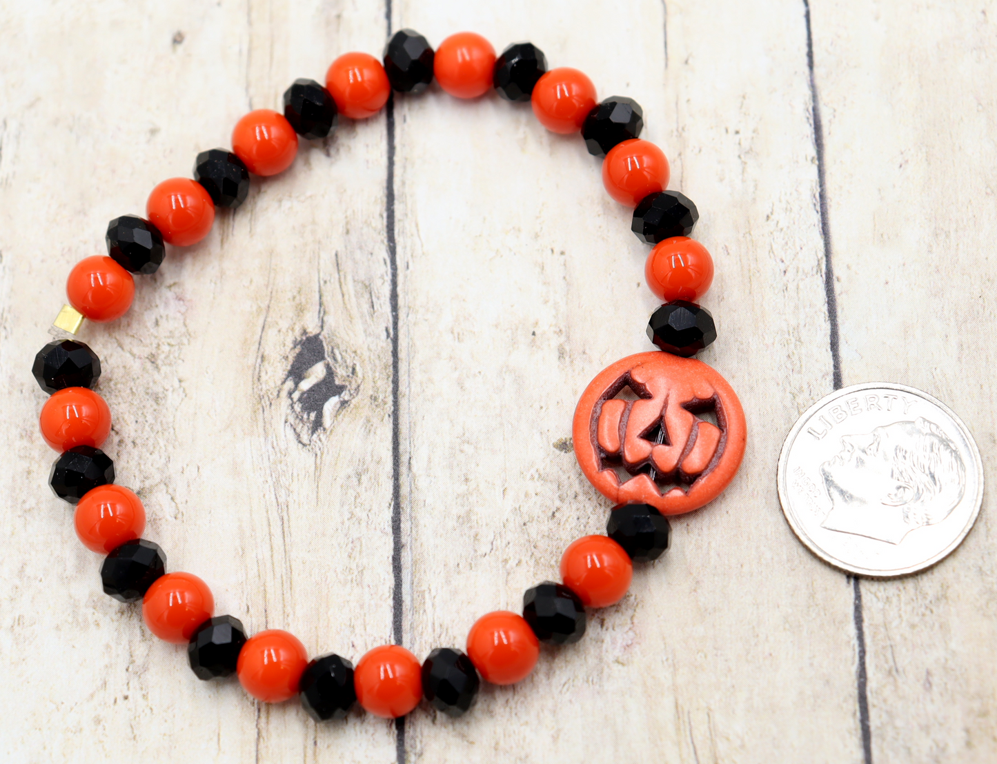 Tricking and Treating Classic Orange and Black Craved Pumpkin Glass Bead Stretch Bracelet by Monkey's Mojo