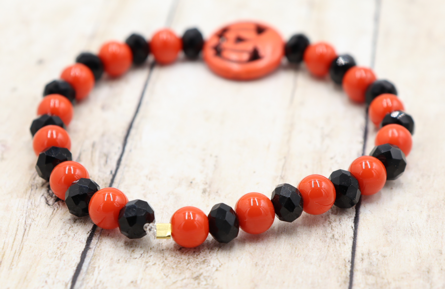 Tricking and Treating Classic Orange and Black Craved Pumpkin Glass Bead Stretch Bracelet by Monkey's Mojo