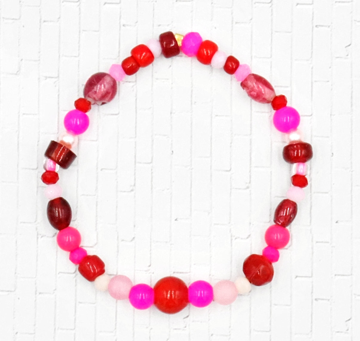 A Bite Out of Our Cherry Hot Pink and Various Red Glass Beaded Bracelet by Monkeys Mojo