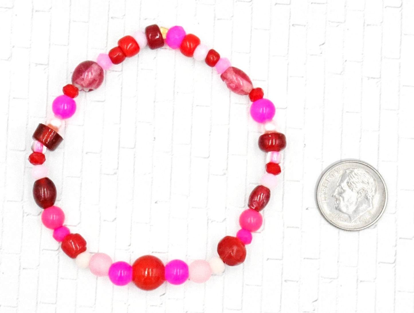 A Bite Out of Our Cherry Hot Pink and Various Red Glass Beaded Bracelet by Monkeys Mojo