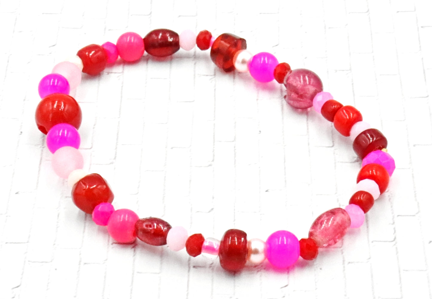 A Bite Out of Our Cherry Hot Pink and Various Red Glass Beaded Bracelet by Monkeys Mojo