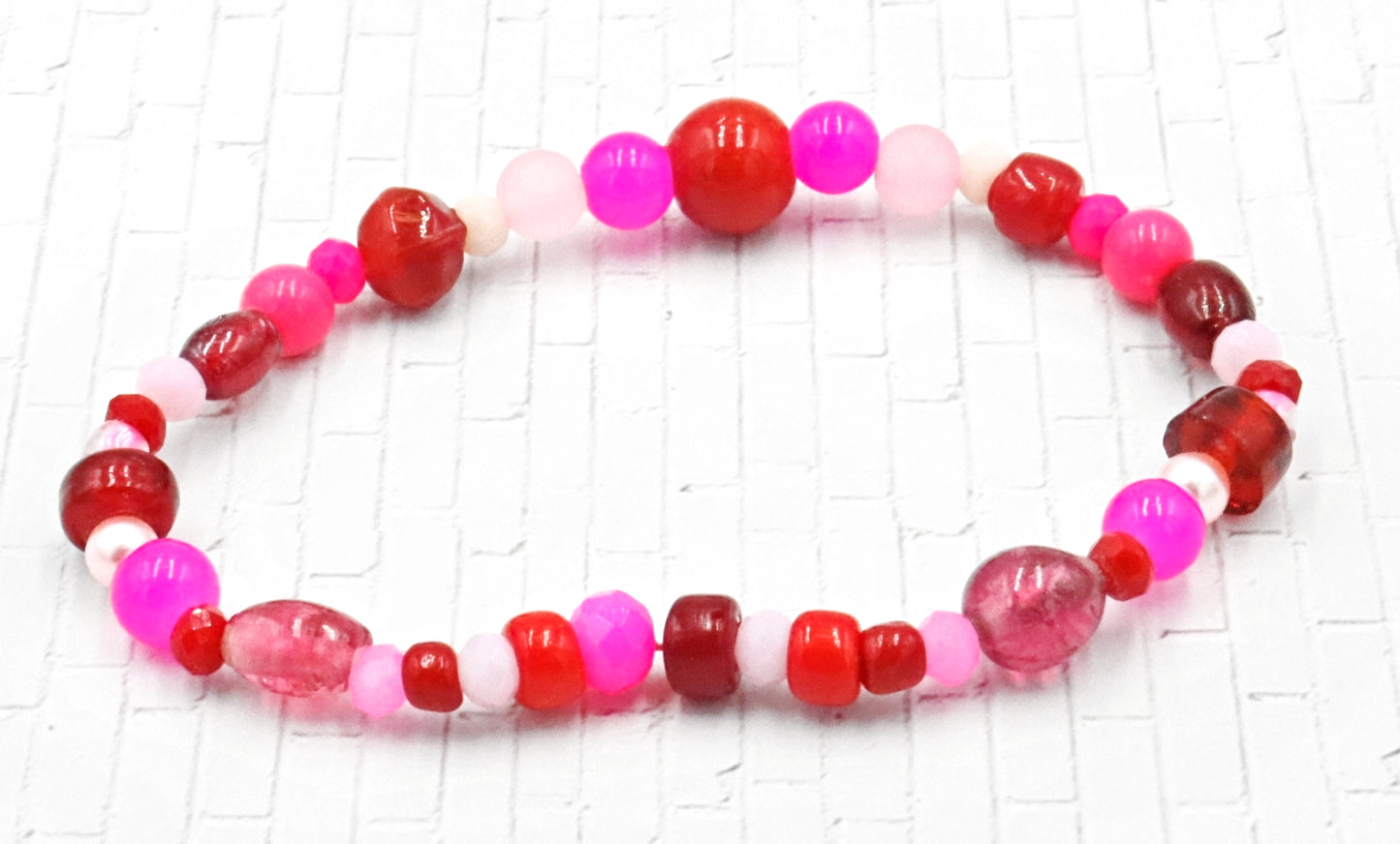 A Bite Out of Our Cherry Hot Pink and Various Red Glass Beaded Bracelet by Monkeys Mojo