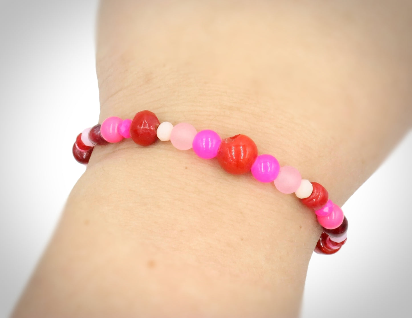 A Bite Out of Our Cherry Hot Pink and Various Red Glass Beaded Bracelet by Monkeys Mojo