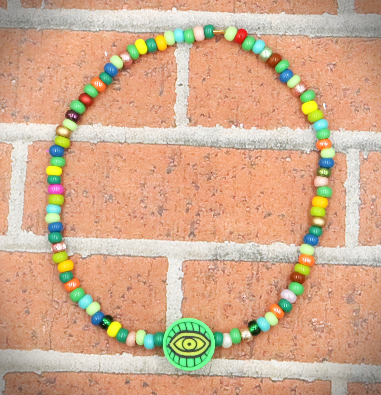 Green Eye of Envy Evil Eye Charm Colorful Seed Bead Stretch Bracelet by Monkey's Mojo