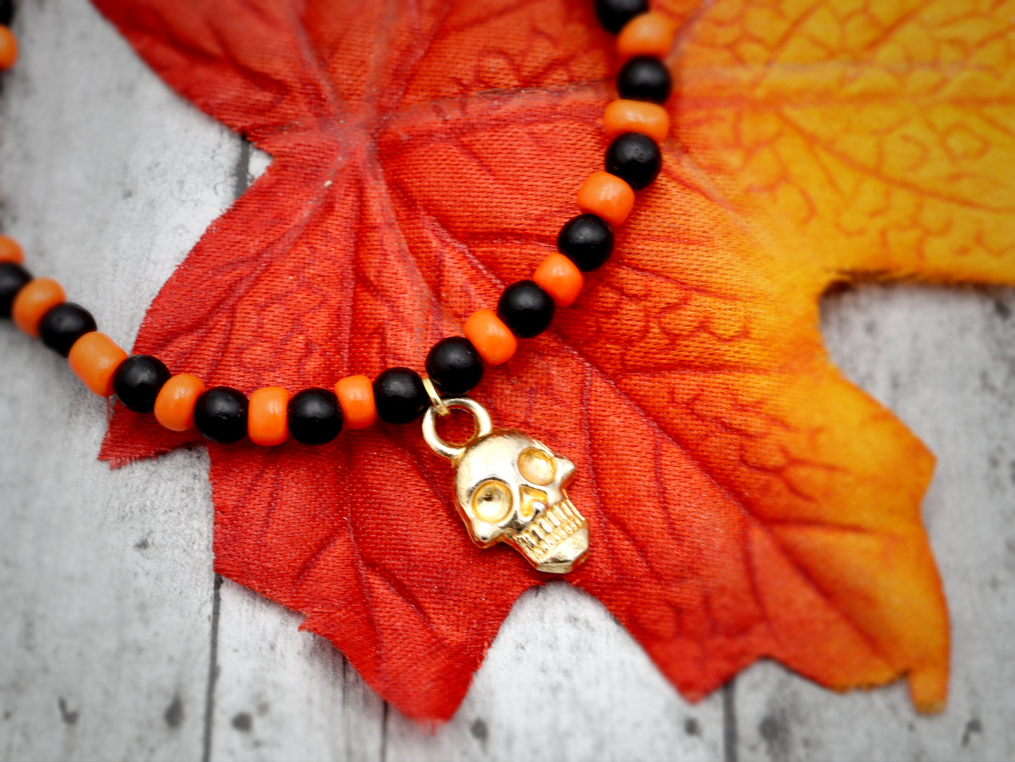 Classic Orange and Black Trick or Treat Yellow Gold Tone Skull Charm Halloween Stretch Bracelet by Monkey's Mojo