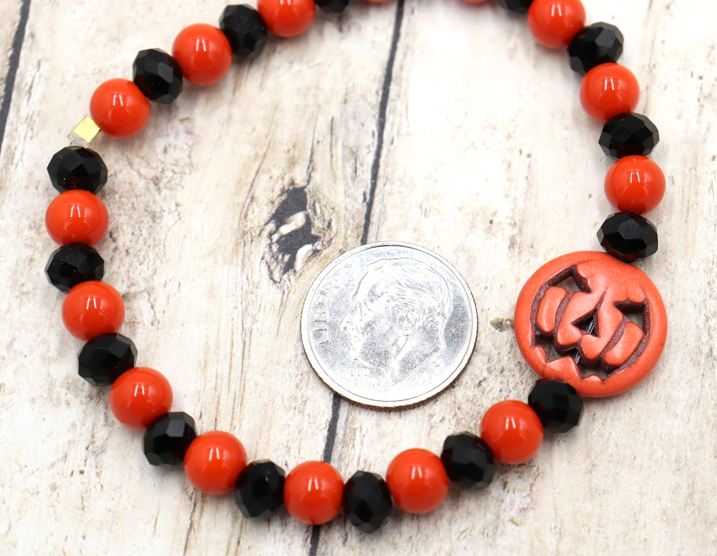 Tricking and Treating Classic Orange and Black Craved Pumpkin Glass Bead Stretch Bracelet by Monkey's Mojo