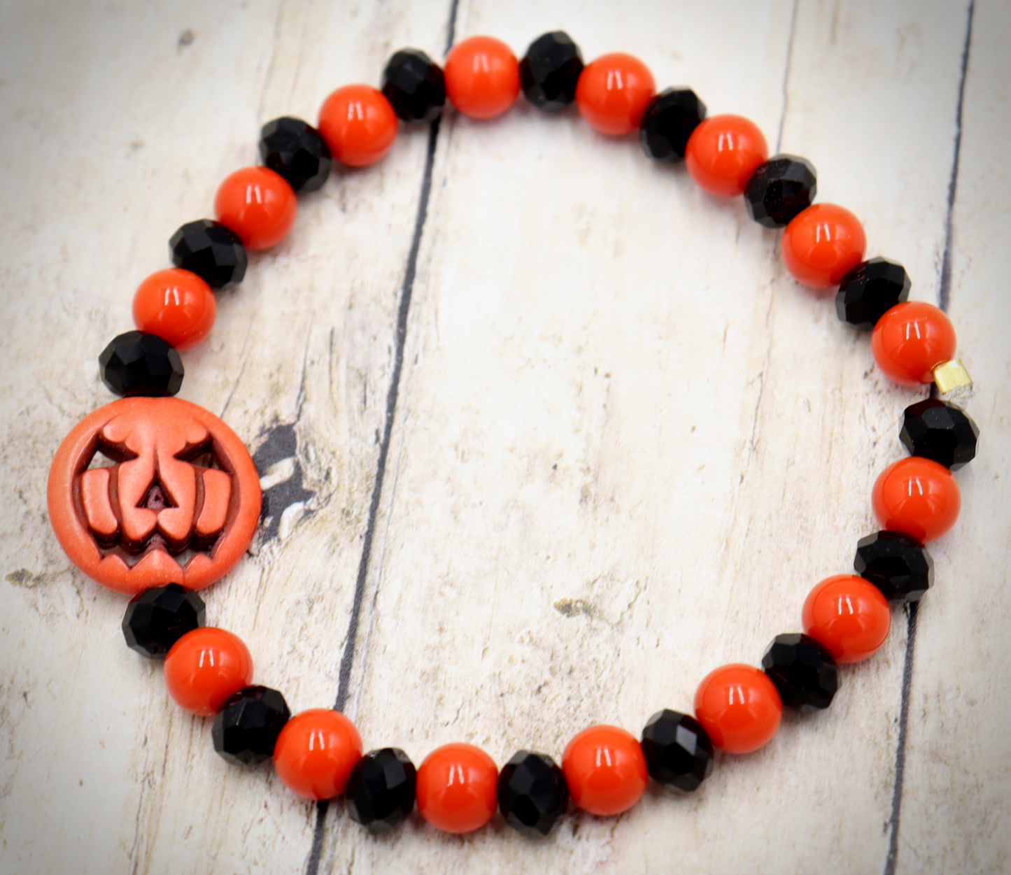 Tricking and Treating Classic Orange and Black Craved Pumpkin Glass Bead Stretch Bracelet by Monkey's Mojo