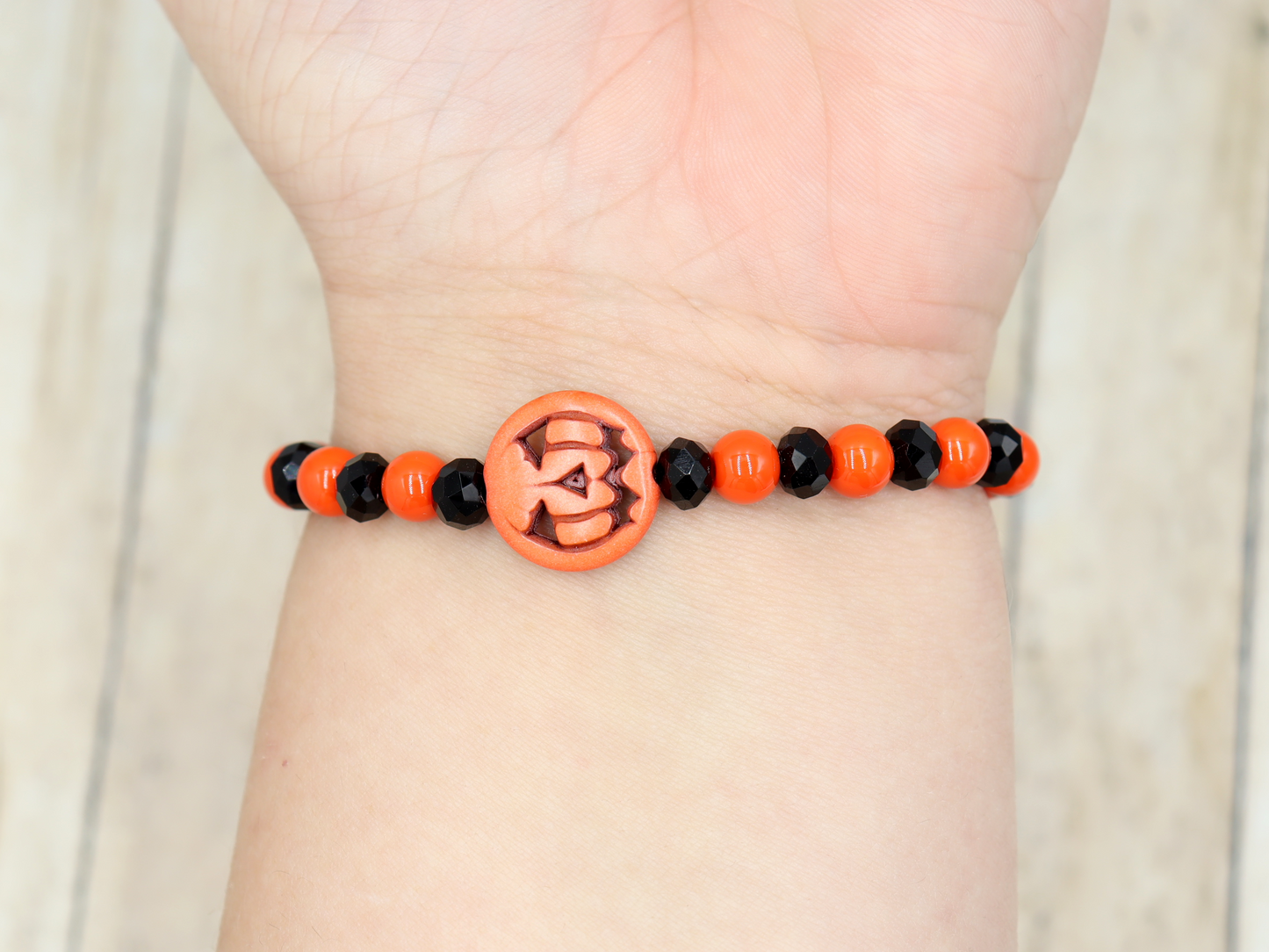 Tricking and Treating Classic Orange and Black Craved Pumpkin Glass Bead Stretch Bracelet by Monkey's Mojo