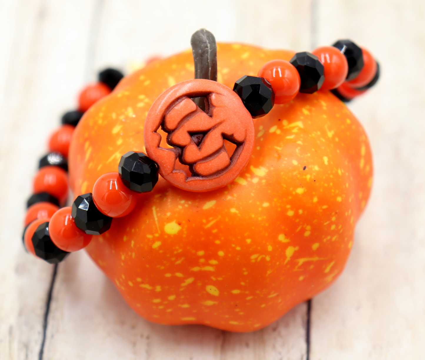 Tricking and Treating Classic Orange and Black Craved Pumpkin Glass Bead Stretch Bracelet by Monkey's Mojo