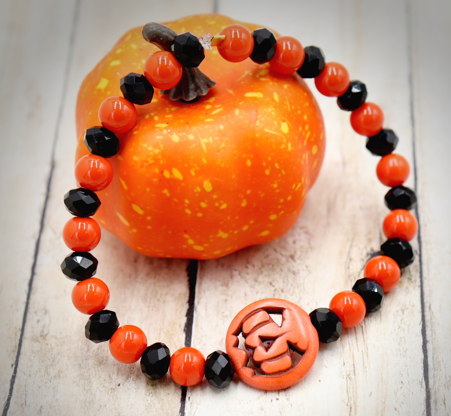 Tricking and Treating Classic Orange and Black Craved Pumpkin Glass Bead Stretch Bracelet by Monkey's Mojo