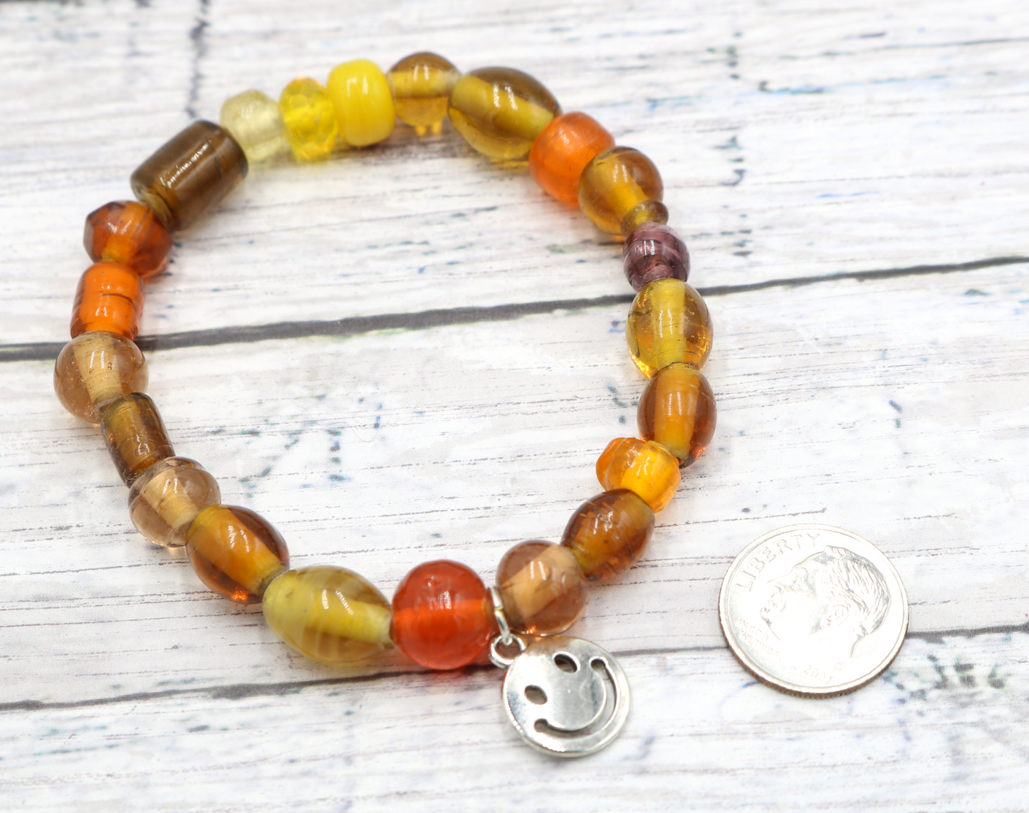 Yellow Hued Warm Artisan Glass Beads Bracelet with Silver Smile Face Charm by Monkey's Mojo