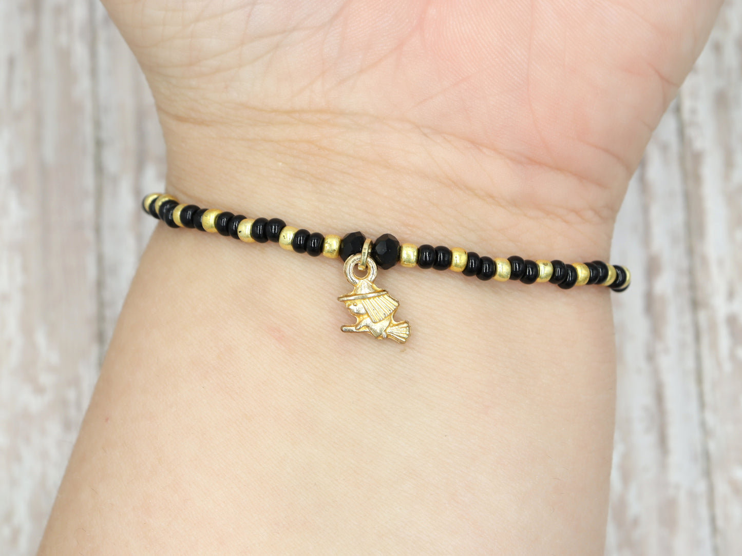 Little Wicked Witch Flying on a Broom Black and Gold Halloween Stretch Bracelet by Monkey's Mojo