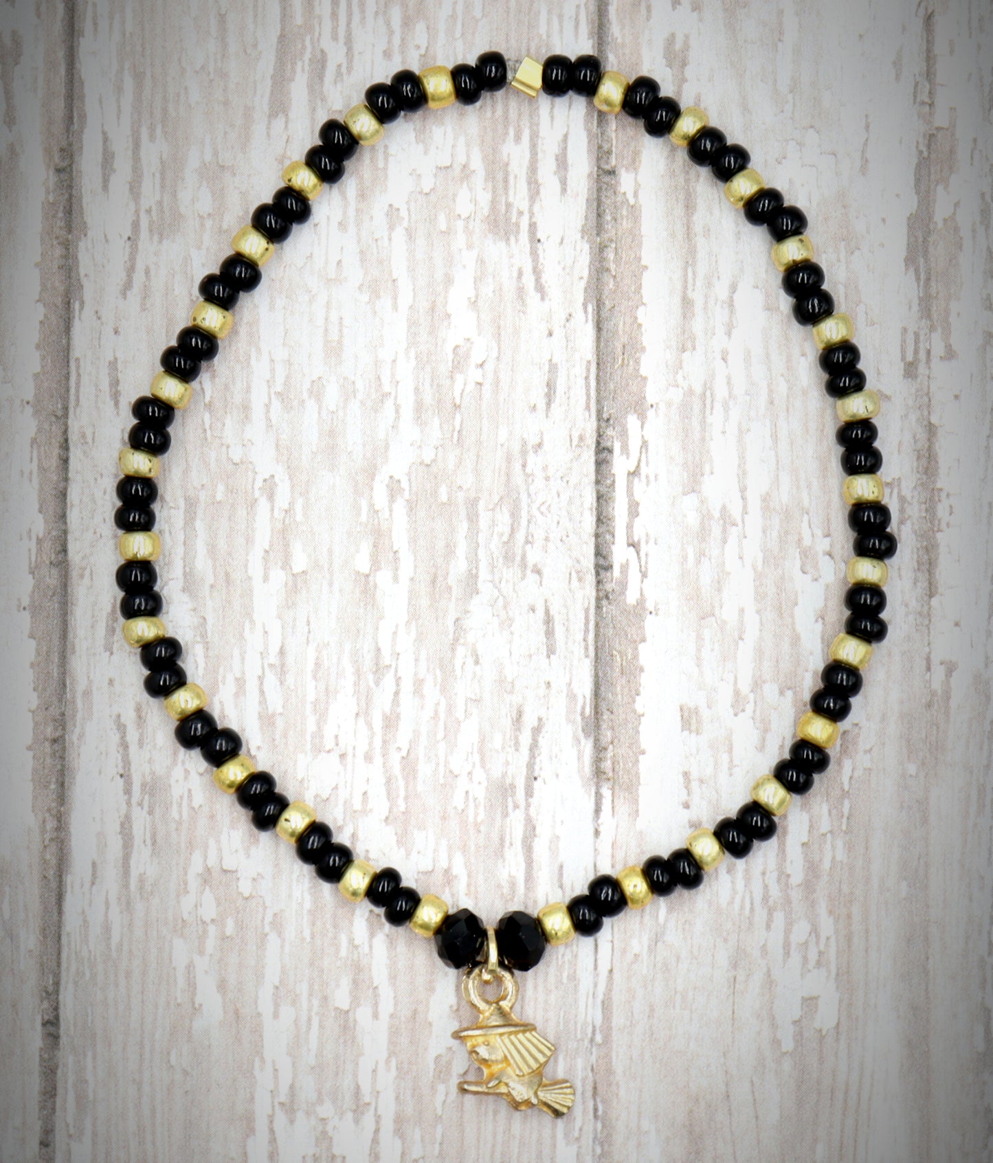 Little Wicked Witch Flying on a Broom Black and Gold Halloween Stretch Bracelet by Monkey's Mojo