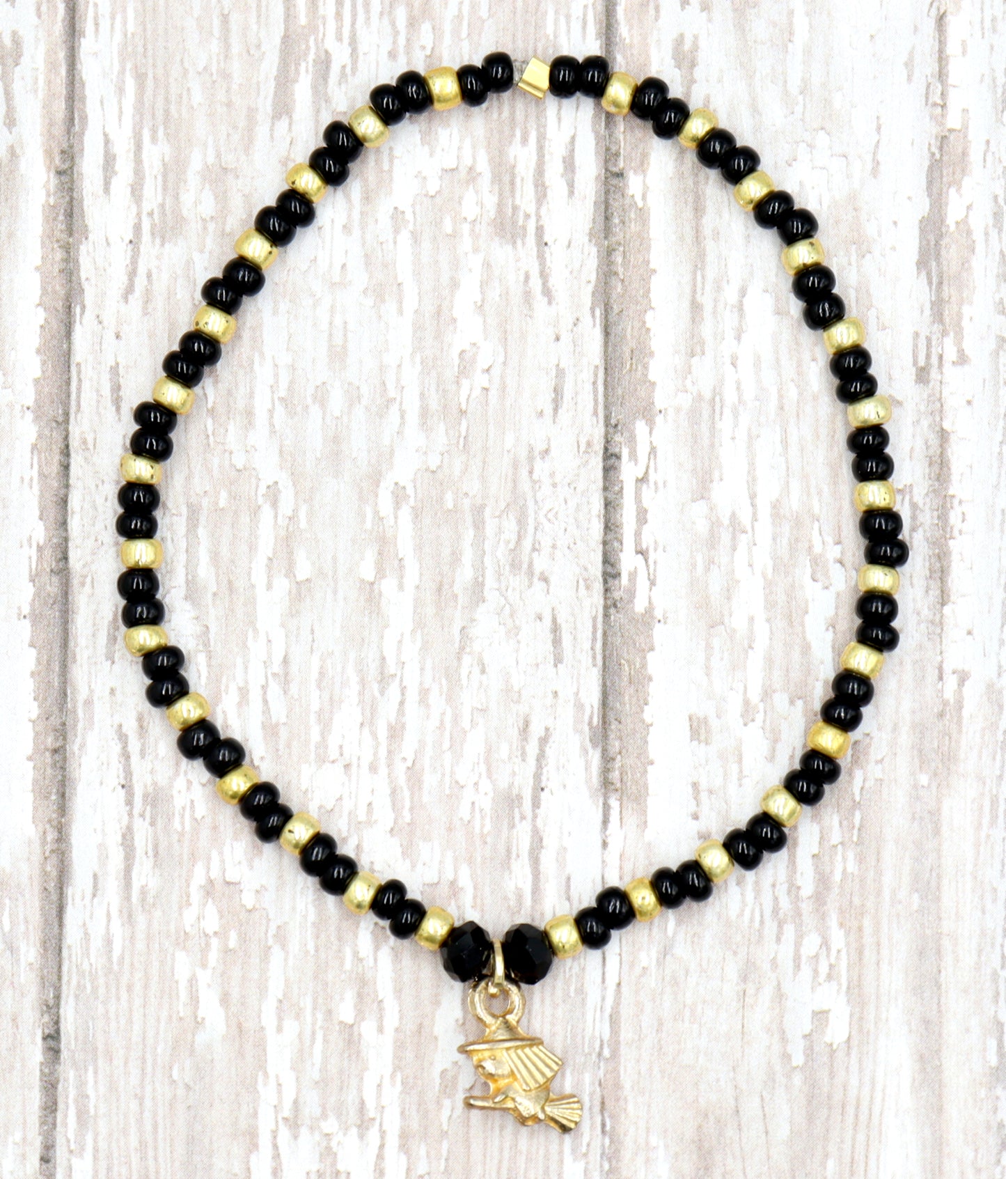 Little Wicked Witch Flying on a Broom Black and Gold Halloween Stretch Bracelet by Monkey's Mojo