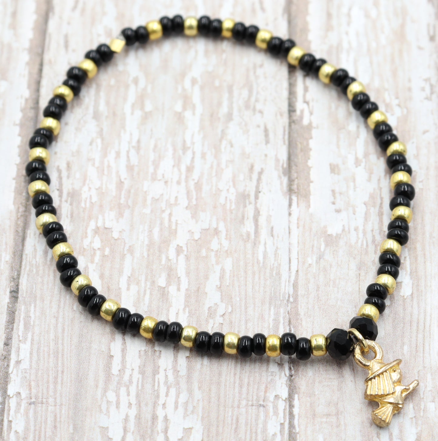 Little Wicked Witch Flying on a Broom Black and Gold Halloween Stretch Bracelet by Monkey's Mojo