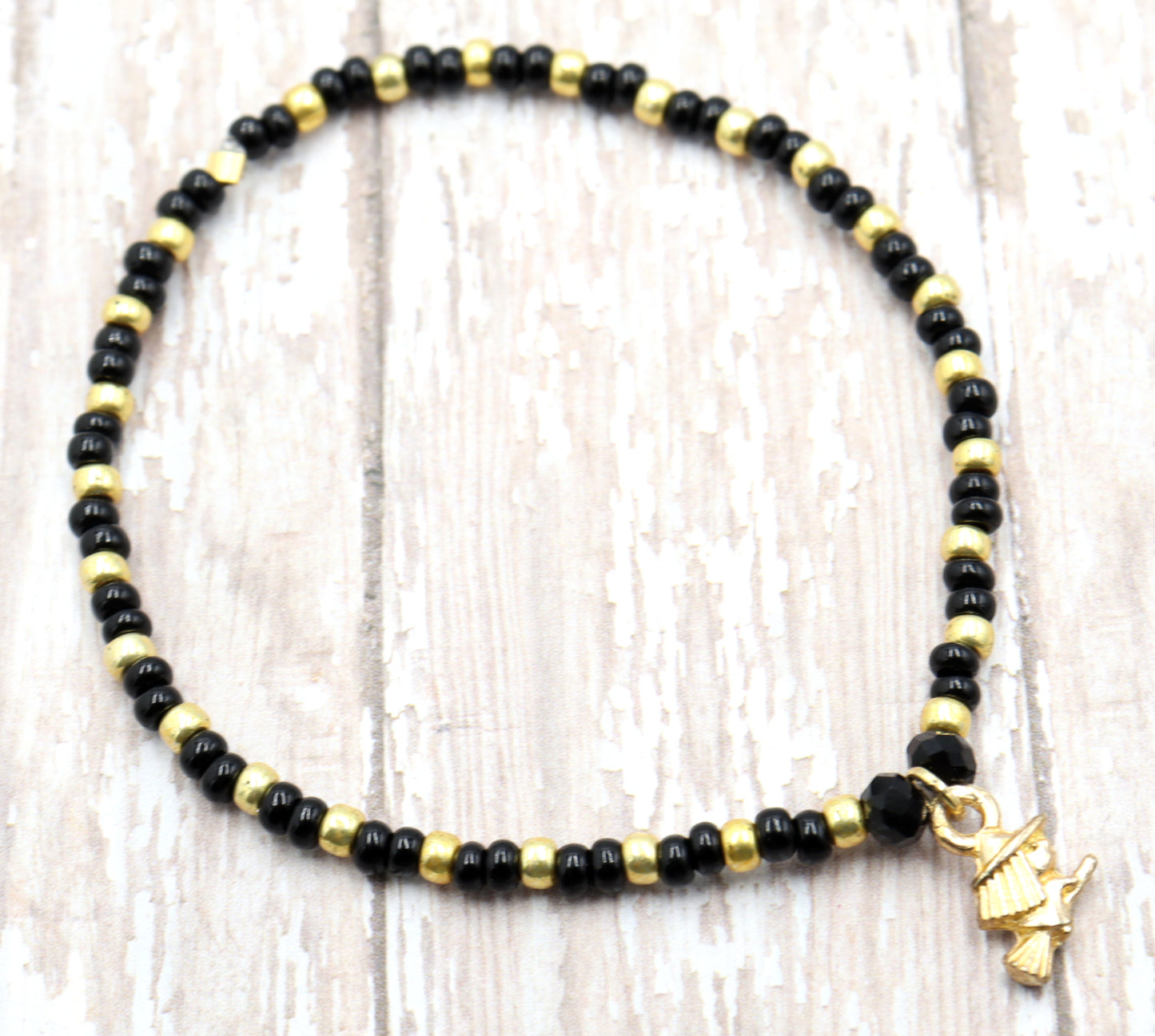 Little Wicked Witch Flying on a Broom Black and Gold Halloween Stretch Bracelet by Monkey's Mojo