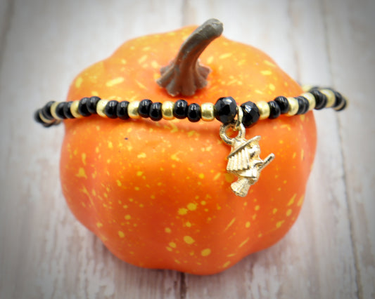 Little Wicked Witch Flying on a Broom Black and Gold Halloween Stretch Bracelet by Monkey's Mojo