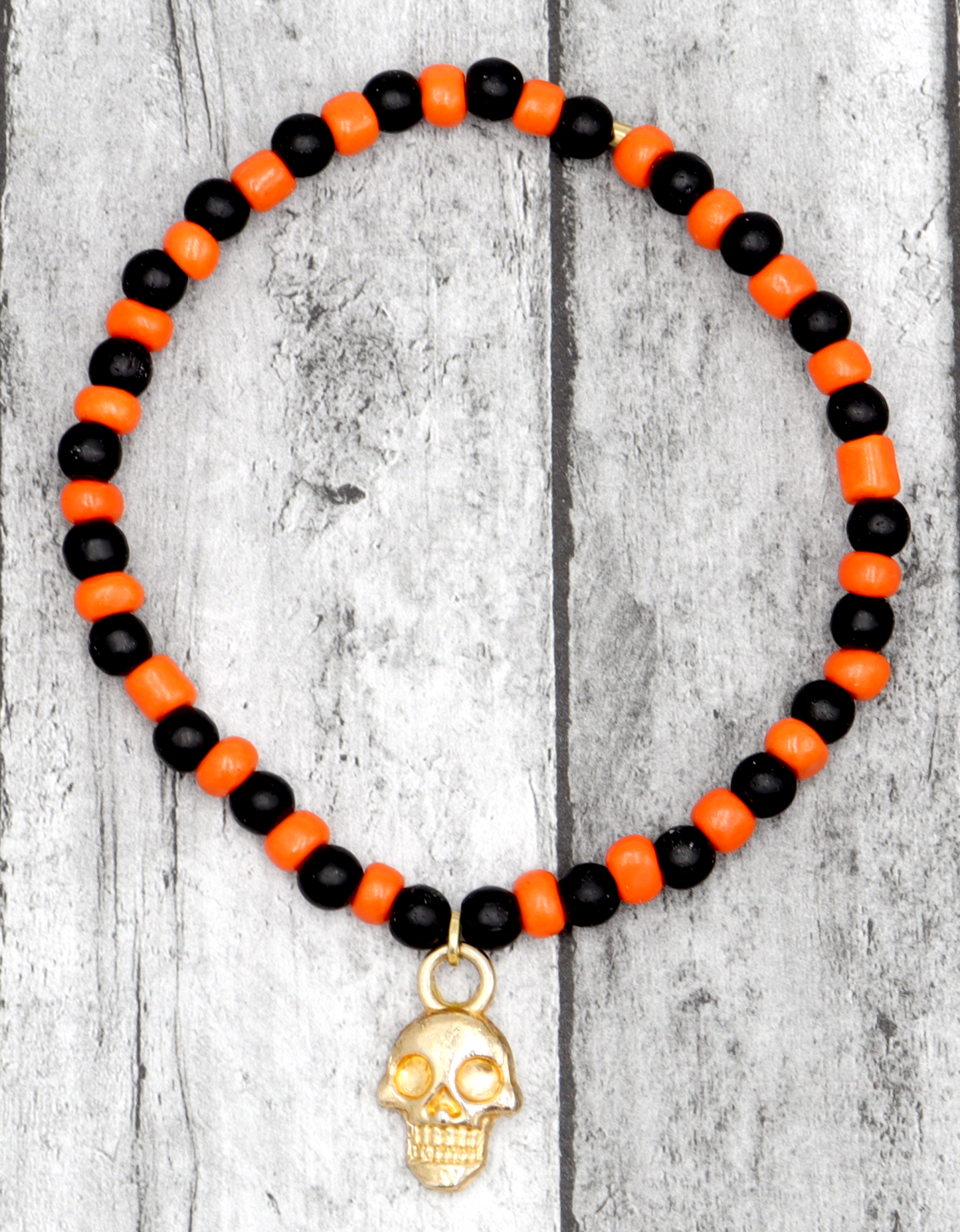 Classic Orange and Black Trick or Treat Yellow Gold Tone Skull Charm Halloween Stretch Bracelet by Monkey's Mojo