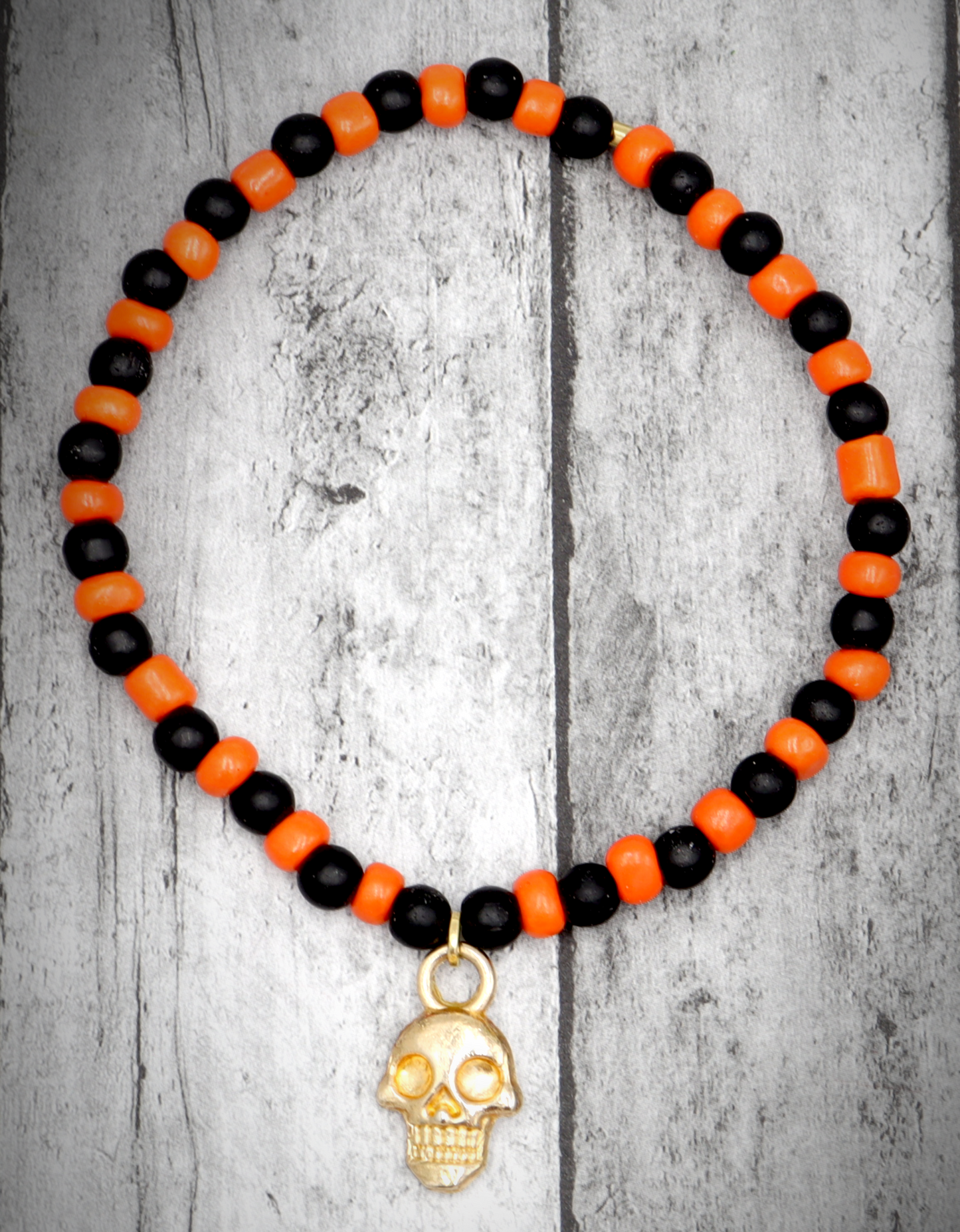 Classic Orange and Black Trick or Treat Yellow Gold Tone Skull Charm Halloween Stretch Bracelet by Monkey's Mojo
