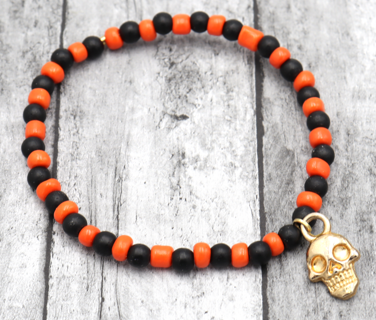 Classic Orange and Black Trick or Treat Yellow Gold Tone Skull Charm Halloween Stretch Bracelet by Monkey's Mojo