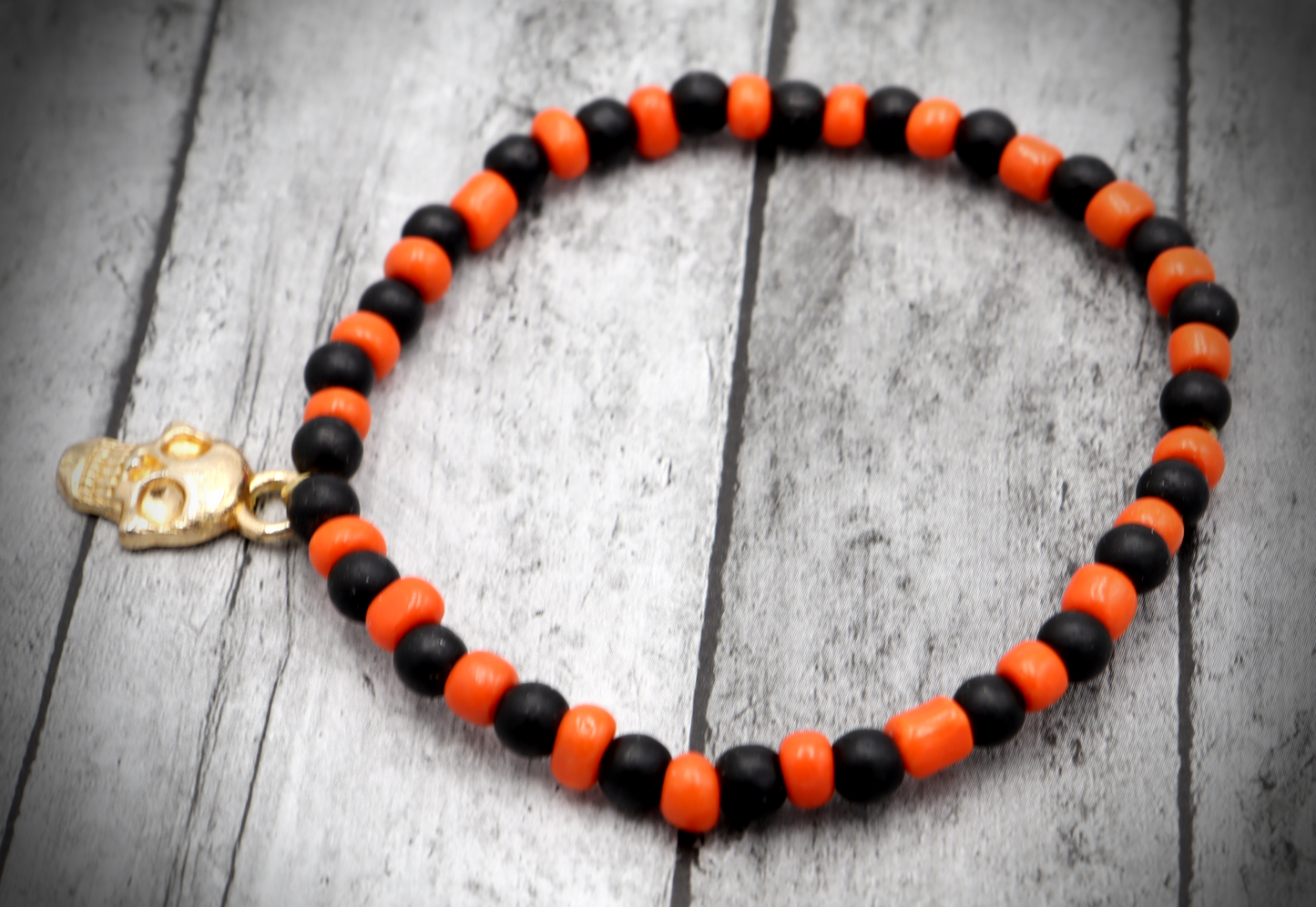 Classic Orange and Black Trick or Treat Yellow Gold Tone Skull Charm Halloween Stretch Bracelet by Monkey's Mojo