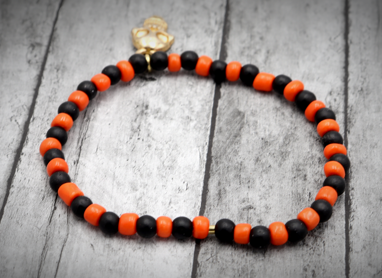 Classic Orange and Black Trick or Treat Yellow Gold Tone Skull Charm Halloween Stretch Bracelet by Monkey's Mojo