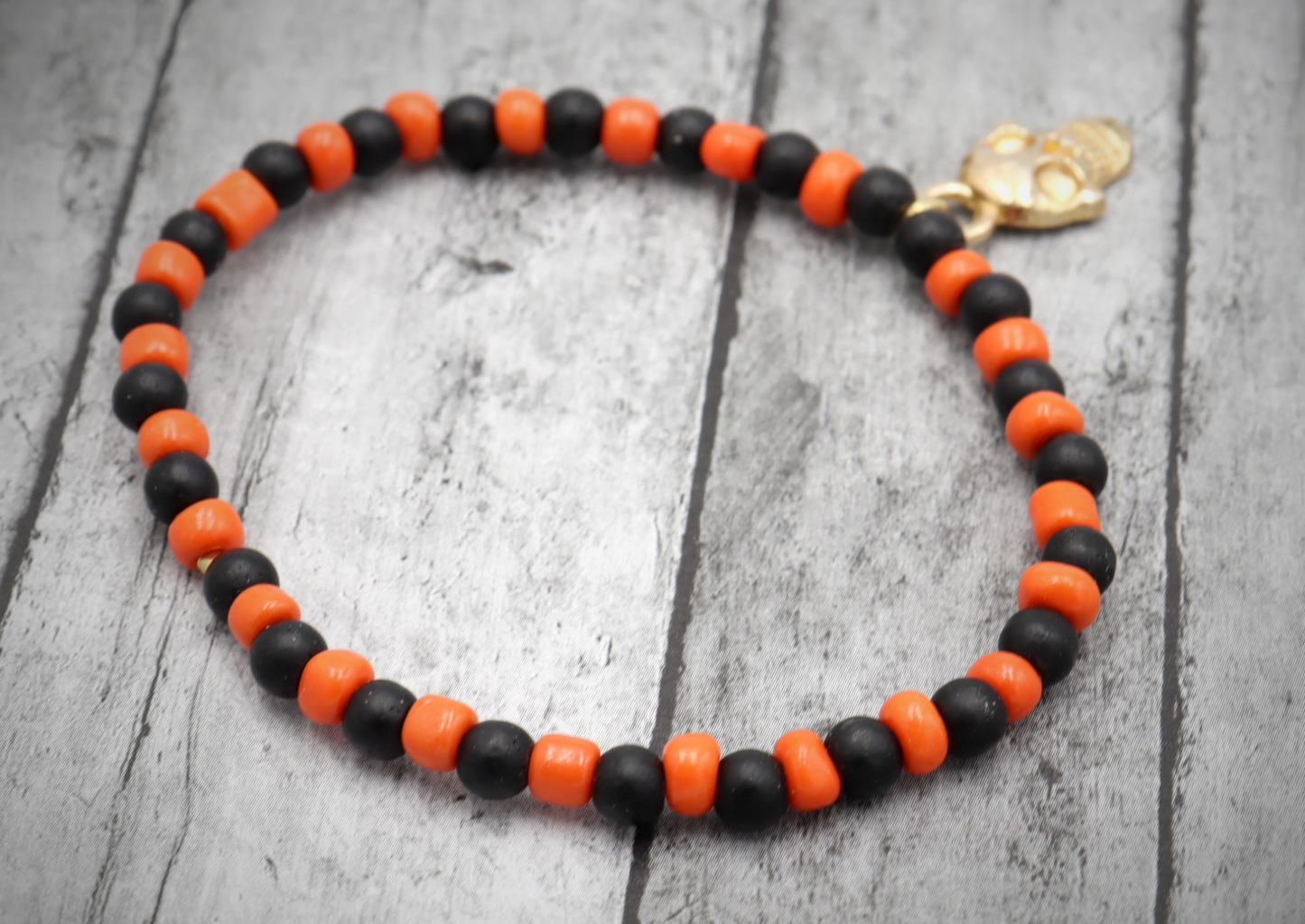 Classic Orange and Black Trick or Treat Yellow Gold Tone Skull Charm Halloween Stretch Bracelet by Monkey's Mojo