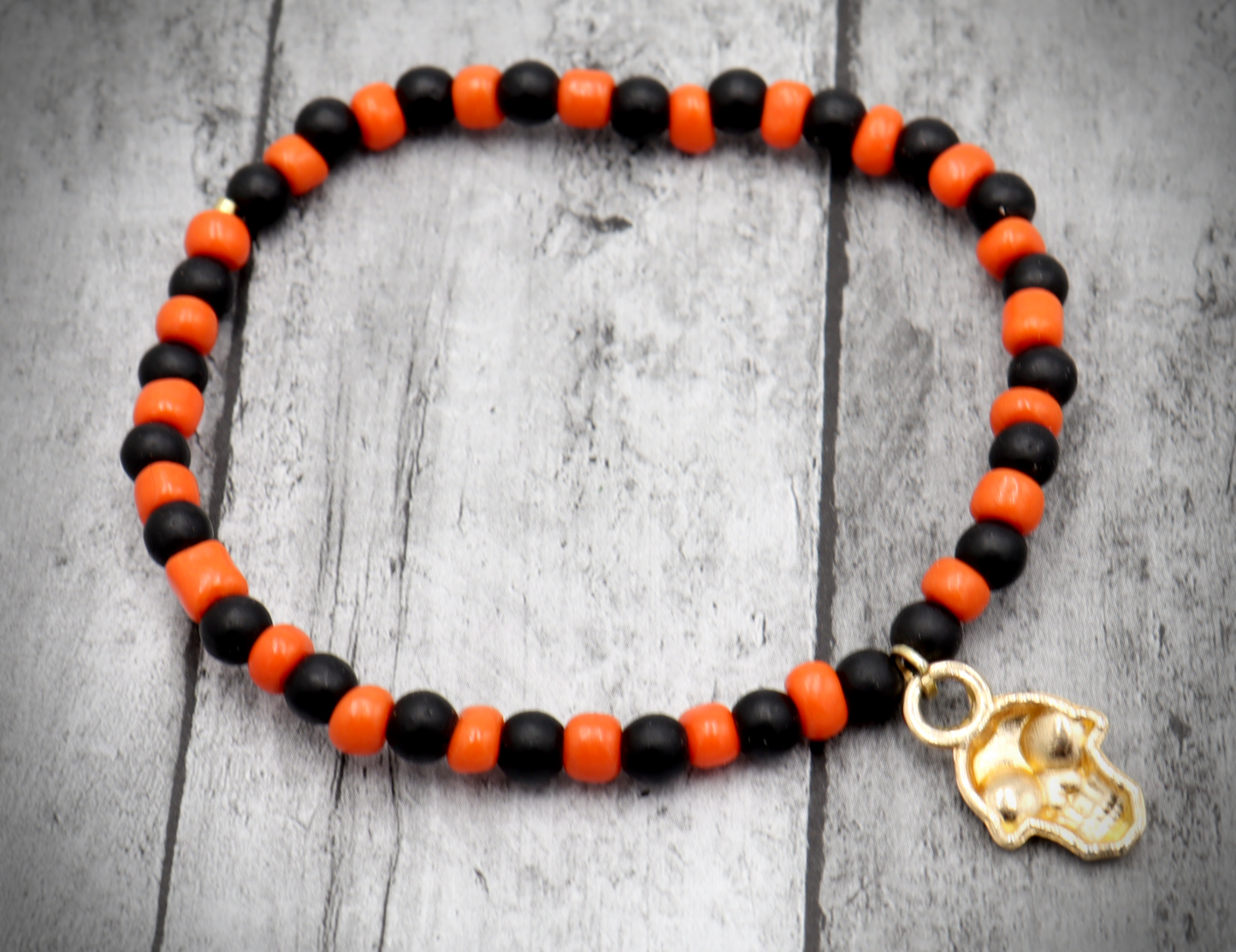 Classic Orange and Black Trick or Treat Yellow Gold Tone Skull Charm Halloween Stretch Bracelet by Monkey's Mojo