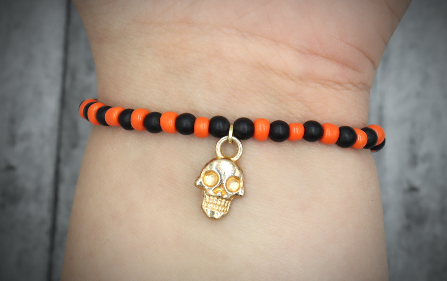 Classic Orange and Black Trick or Treat Yellow Gold Tone Skull Charm Halloween Stretch Bracelet by Monkey's Mojo